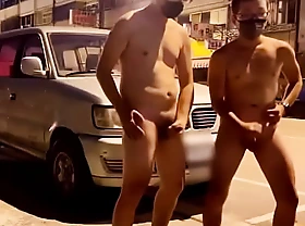 Two Asians cum atop the street